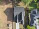A bird's-eye view of a gray roof with a long driveway and landscaped greenery surrounding the house at 1904 French Dr, Raleigh, NC 27612