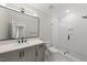 Modern bathroom featuring a glass-enclosed shower, sleek vanity, and a large mirror at 1904 French Dr, Raleigh, NC 27612
