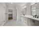 Bathroom featuring double vanity with modern fixtures, marble floors, and a glass-enclosed shower at 1904 French Dr, Raleigh, NC 27612