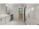 Bathroom featuring double vanity with modern fixtures, marble floors, and a glass-enclosed shower at 1904 French Dr, Raleigh, NC 27612