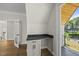 Bedroom with hardwood floors, built-in desk and sliding glass doors to balcony at 1904 French Dr, Raleigh, NC 27612