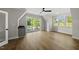 Bright bedroom featuring hardwood floors, ceiling fan and sliding glass doors at 1904 French Dr, Raleigh, NC 27612