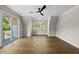 Bedroom with hardwood floors, ceiling fan and three-window view at 1904 French Dr, Raleigh, NC 27612
