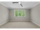 Bedroom featuring neutral paint and carpet, ceiling fan and window view at 1904 French Dr, Raleigh, NC 27612