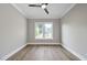 Sunlit bedroom features hardwood floors, neutral walls, and a modern ceiling fan at 1904 French Dr, Raleigh, NC 27612