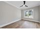 Bright bedroom with hardwood floors, a ceiling fan, and a double window at 1904 French Dr, Raleigh, NC 27612