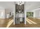 A butler pantry with gray cabinets, a sink, a white countertop, and overhead cabinets featuring glass doors at 1904 French Dr, Raleigh, NC 27612