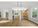 Elegant dining area with modern chandelier and wood-paneled accent wall at 1904 French Dr, Raleigh, NC 27612