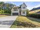 Beautiful new construction home with a black garage door, second-story balcony, and green lawn at 1904 French Dr, Raleigh, NC 27612
