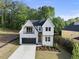 Charming two-story home with landscaped yard and a black garage door at 1904 French Dr, Raleigh, NC 27612