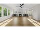 Sunlit living room featuring a fireplace with marble surround and custom built-in cabinetry at 1904 French Dr, Raleigh, NC 27612