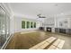 Spacious living room with fireplace, abundant natural light, and a modern ceiling fan at 1904 French Dr, Raleigh, NC 27612