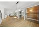 Open-concept living space with hardwood floors and modern lighting fixtures at 1904 French Dr, Raleigh, NC 27612