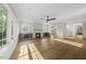 Open concept living room with a fireplace, modern lighting, and hardwood floors at 1904 French Dr, Raleigh, NC 27612