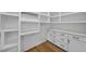Walk-in pantry featuring white cabinets, open shelving, and solid surface countertops at 1904 French Dr, Raleigh, NC 27612
