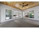 Spacious sunroom features wood ceilings, fireplace, and large sliding glass doors to the exterior at 1904 French Dr, Raleigh, NC 27612