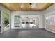 Cozy sunroom showcasing wood ceiling, large windows, and views of the home's open floor plan at 1904 French Dr, Raleigh, NC 27612