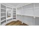 Spacious walk-in closet with custom shelving, hanging rods and mirror at 1904 French Dr, Raleigh, NC 27612