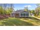 Back exterior view with sunroom and manicured lawn at 2005 Delphi Way, Wake Forest, NC 27587