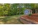 Landscaped backyard with shed and retaining wall at 2005 Delphi Way, Wake Forest, NC 27587