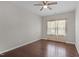 Simple bedroom features hardwood floors, neutral walls, and a window with sheer curtains at 2005 Delphi Way, Wake Forest, NC 27587