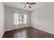 Bright bedroom with hardwood floors, ceiling fan, and window providing ample natural light at 2005 Delphi Way, Wake Forest, NC 27587