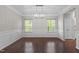 Dining room with hardwood floors and white wainscoting gets natural light at 2005 Delphi Way, Wake Forest, NC 27587