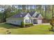 Charming home exterior with well-maintained landscaping and attached garage at 2005 Delphi Way, Wake Forest, NC 27587