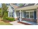 Inviting front porch featuring stone accents and blue shutters at 2005 Delphi Way, Wake Forest, NC 27587