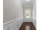 Entry hall features hardwood floors, wainscoting, and a storm door at 2005 Delphi Way, Wake Forest, NC 27587