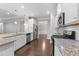 Modern kitchen with granite countertops, stainless steel appliances, open floor plan, and hardwood floors at 2005 Delphi Way, Wake Forest, NC 27587