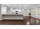 Open-concept kitchen and living area featuring granite countertops, stainless steel appliances, and hardwood floors at 2005 Delphi Way, Wake Forest, NC 27587