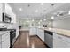 Well-equipped kitchen featuring stainless steel appliances, granite countertops, and open layout to the living area at 2005 Delphi Way, Wake Forest, NC 27587