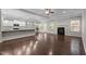 Spacious living room with hardwood floors, a cozy fireplace, and natural light from large windows at 2005 Delphi Way, Wake Forest, NC 27587