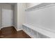 Mudroom features storage bench, white bead board, and hardwood floors at 2005 Delphi Way, Wake Forest, NC 27587