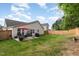 Fenced backyard featuring a patio area, seating and a well-maintained lawn at 205 Braxcarr St, Holly Springs, NC 27540