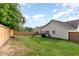 Spacious fenced backyard featuring a patio area, and a well-maintained lawn at 205 Braxcarr St, Holly Springs, NC 27540