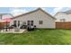 Backyard with a patio seating area, lush lawn, and a well-kept exterior at 205 Braxcarr St, Holly Springs, NC 27540