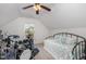Bright bedroom features vaulted ceiling, drum set, and day bed at 205 Braxcarr St, Holly Springs, NC 27540