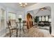 Bright breakfast nook with a glass table, two chairs, and seamless access to the living area at 205 Braxcarr St, Holly Springs, NC 27540