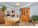 Charming dining area showcases a round table, chairs, and a built-in wooden cabinet for ample storage at 205 Braxcarr St, Holly Springs, NC 27540