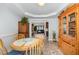 Inviting dining area featuring hardwood floors and seamless connection to the living room through an archway at 205 Braxcarr St, Holly Springs, NC 27540