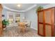 Dining room featuring hardwood floors, modern light fixtures, and a cozy atmosphere at 205 Braxcarr St, Holly Springs, NC 27540