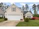 Charming single-story home with a well-manicured lawn, attached garage, and inviting front entrance, exuding curb appeal at 205 Braxcarr St, Holly Springs, NC 27540