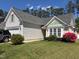 Charming home featuring mature landscaping, lush lawn and welcoming curb appeal at 205 Braxcarr St, Holly Springs, NC 27540