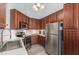 Well-equipped kitchen featuring stainless steel appliances, dark wood cabinetry, and ample countertop space at 205 Braxcarr St, Holly Springs, NC 27540