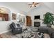 Open concept living room with fireplace, hardwood floors, and bright natural light at 205 Braxcarr St, Holly Springs, NC 27540