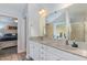 Bright bathroom features double sinks, granite countertops and a walk-in shower at 205 Braxcarr St, Holly Springs, NC 27540