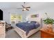 Bright main bedroom with a comfortable bed, ceiling fan, and serene decor at 205 Braxcarr St, Holly Springs, NC 27540