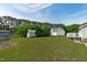 A sprawling backyard featuring an outbuilding and partial view of the back of the home at 205 Twin Oaks Dr, Angier, NC 27501